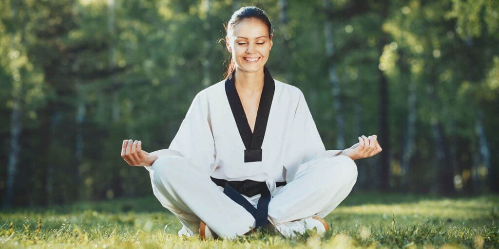 Martial Arts Lessons for Adults in Butte MT - Happy Woman Meditated Sitting Background